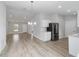 Open dining room with wood-look floors and chandelier at 15499 Sw 27Th Ln, Ocala, FL 34481