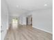 Open living room with vinyl plank flooring and sliding glass doors at 15499 Sw 27Th Ln, Ocala, FL 34481