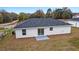 Single-story home with gray roof and sliding glass doors at 15499 Sw 27Th Ln, Ocala, FL 34481