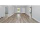 Open concept living room with wood-look floors and multiple entries at 15499 Sw 27Th Ln, Ocala, FL 34481