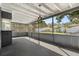 Screened porch with gray flooring, bar area, and backyard view at 3220 Crooked Oak Ct, Orlando, FL 32808