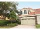 Two-story townhome with a tan facade and two-car garage at 7126 Regina Way, Orlando, FL 32819