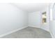 Well-lit bedroom featuring grey carpet and a window at 7126 Regina Way, Orlando, FL 32819