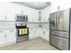 Modern kitchen with stainless steel appliances and white shaker cabinets at 7126 Regina Way, Orlando, FL 32819