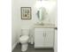 Powder room with white vanity and oval mirror at 7126 Regina Way, Orlando, FL 32819