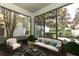 Cozy screened porch with wicker furniture and a view of the backyard at 7126 Regina Way, Orlando, FL 32819