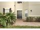 Charming house exterior with a dark-colored front door and brick walkway at 7126 Regina Way, Orlando, FL 32819