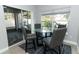 Breakfast nook with glass table and four gray chairs, near sliding glass doors at 7126 Regina Way, Orlando, FL 32819