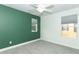 Bedroom with green accent wall and grey carpet at 7126 Regina Way, Orlando, FL 32819