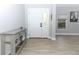 Inviting entryway with a stylish console table and wood-look floors at 7126 Regina Way, Orlando, FL 32819