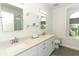 Modern bathroom with double vanity and glass shower at 7126 Regina Way, Orlando, FL 32819