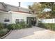 Private brick patio adjacent to the house with lush landscaping at 7126 Regina Way, Orlando, FL 32819
