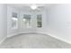 Bright bedroom with ceiling fan and grey carpeting at 7126 Regina Way, Orlando, FL 32819