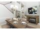 Elegant dining room featuring a wood table, fireplace, and chandelier at 7126 Regina Way, Orlando, FL 32819