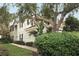 Two-story house exterior with landscaping and a brick pathway at 7126 Regina Way, Orlando, FL 32819