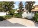 Landscaped backyard with a brick patio and a white fence at 7126 Regina Way, Orlando, FL 32819