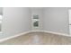 Bright bedroom with wood-look floors and neutral walls at 7126 Regina Way, Orlando, FL 32819