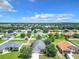 Neighborhood view with houses, yards, and some trees at 5411 Great Egret Dr, Leesburg, FL 34748