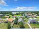 Aerial view of a residential neighborhood with houses, yards and a lake at 5411 Great Egret Dr, Leesburg, FL 34748