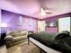 Bedroom with couch, king bed, and purple walls at 5411 Great Egret Dr, Leesburg, FL 34748