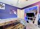 Purple bedroom with a double bed, a built-in media center, and a large closet at 5411 Great Egret Dr, Leesburg, FL 34748