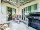 Covered patio with sliding glass doors, outdoor seating and a gas grill at 5411 Great Egret Dr, Leesburg, FL 34748
