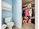 Small bathroom with toilet and a large closet for storage at 5411 Great Egret Dr, Leesburg, FL 34748