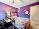 Cozy bedroom with a double bed, a small desk, and purple walls at 5411 Great Egret Dr, Leesburg, FL 34748