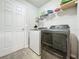 Laundry room with washer, dryer, and overhead storage at 5411 Great Egret Dr, Leesburg, FL 34748
