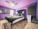 Large bedroom with a king-size bed and purple walls at 5411 Great Egret Dr, Leesburg, FL 34748