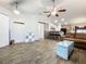 Open concept living area with tile floors and a sliding glass door at 5411 Great Egret Dr, Leesburg, FL 34748