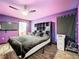 Bedroom with king-size bed and purple walls at 5411 Great Egret Dr, Leesburg, FL 34748