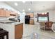 Kitchen boasts ample wood cabinets, tile floors, and black appliances at 5411 Great Egret Dr, Leesburg, FL 34748