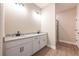 Bathroom with double vanity, white cabinets, and a shower at 7836 Somersworth Dr, Kissimmee, FL 34747