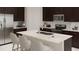 Modern kitchen with dark cabinetry, quartz countertops and island at 4783 Cloister St, Kissimmee, FL 34758