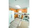 Kitchen with wood cabinets, stainless steel appliances, and granite countertops at 13415 Blue Heron Beach Dr # 1101, Orlando, FL 32821