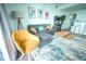 Bright living room featuring comfortable seating, a stylish coffee table, and a retro arcade game at 13415 Blue Heron Beach Dr # 1101, Orlando, FL 32821