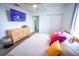 Spacious main bedroom with a king-size bed, dresser, and large TV at 13415 Blue Heron Beach Dr # 1101, Orlando, FL 32821