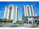 Twin highrise building exterior with fountain and landscaping at 13415 Blue Heron Beach Dr # 1101, Orlando, FL 32821