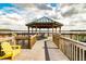 Wooden dock with gazebo and seating at 13415 Blue Heron Beach Dr # 1101, Orlando, FL 32821