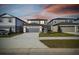 Two-story home with grey garage door and landscaping at 301 Woodsage Pl, Lake Alfred, FL 33850