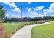 Tennis courts with a walking path and lush landscaping at 251 Tomelloso Way, Davenport, FL 33837