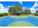 Outdoor community basketball court with blue and green surface at 251 Tomelloso Way, Davenport, FL 33837
