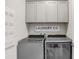 Laundry room with cabinets and Whirlpool washer/dryer at 251 Tomelloso Way, Davenport, FL 33837