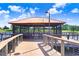 Lakeside gazebo with seating area on a wooden deck at 251 Tomelloso Way, Davenport, FL 33837