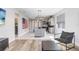 Open living room with kitchen view, hardwood floors, and modern furniture at 251 Tomelloso Way, Davenport, FL 33837