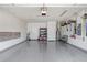 Two-car garage with epoxy floors and storage shelving at 251 Tomelloso Way, Davenport, FL 33837