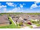 Aerial view of house showcasing its location in a residential neighborhood at 251 Tomelloso Way, Davenport, FL 33837