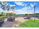 Community patio with yellow umbrellas and seating near a lake at 251 Tomelloso Way, Davenport, FL 33837