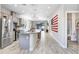 Open-concept kitchen with island, granite countertops, and stainless steel appliances at 251 Tomelloso Way, Davenport, FL 33837